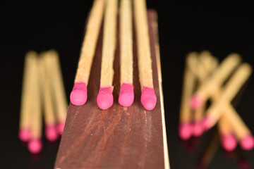 Matches made of wood, close-up, on a black background.