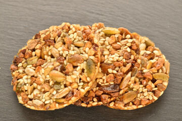 A few delicious walnut cookies, close-up, on a slate board.