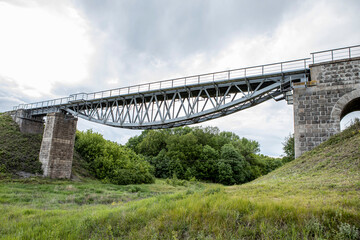 The beautiful high railway bridge. Metal construction