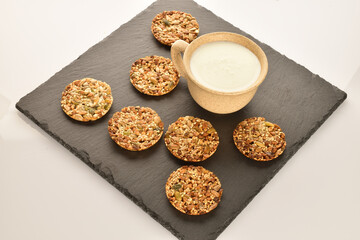 A few delicious walnut cookies, close-up, on a slate board.