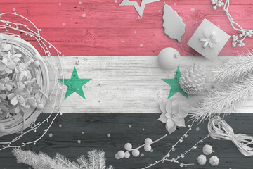 Syria flag on wooden table with snow objects. Christmas and new year background, celebration...