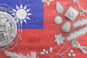 Taiwan flag on wooden table with snow objects. Christmas and new year background, celebration national concept with white decor.