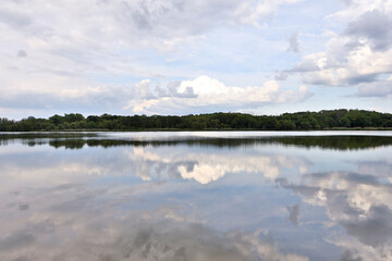 Beautiful clouds reflected on the blue lake surface