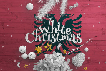 Albania flag on wooden table with White Christmas text. Christmas and new year background, celebration national concept with white decor.