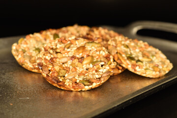 Several fresh fragrant tasty nutty cookies on a black background.