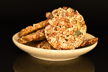 Several fresh fragrant tasty nutty cookies on a black background.