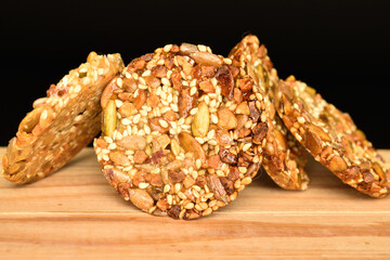 Several fresh fragrant tasty nutty cookies on a black background.