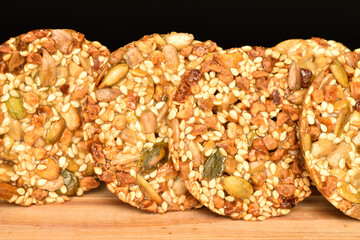 Several fresh fragrant tasty nutty cookies on a black background.