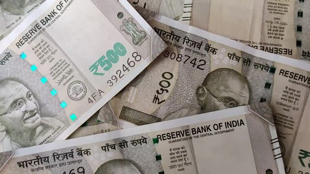 Slow Motion Closeup of brand new 500 Rs green colorful Indian currency bank notes issued and in circulation after demonetisation