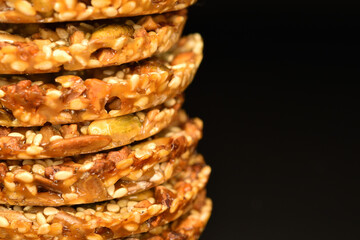 Several fresh fragrant tasty nutty cookies on a black background.