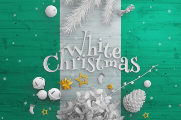 Nigeria flag on wooden table with White Christmas text. Christmas and new year background,...