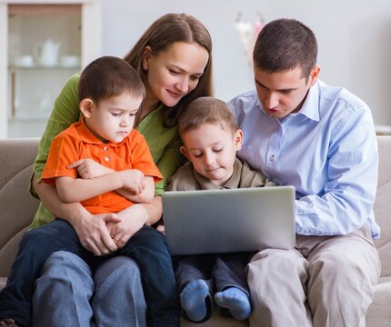 Young family surfing internet and looking at photos