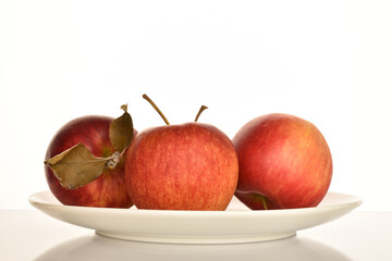 Ripe red apples, close-up, on a white background.