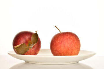 Ripe red apples, close-up, on a white background.