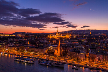 Obraz premium Aerial drone of lighted Matthias Church on Buda hill during Budapest sunset