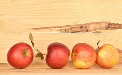 Ripe red apples, close-up, on a background of natural wood.