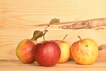 Ripe red apples, close-up, on a background of natural wood.