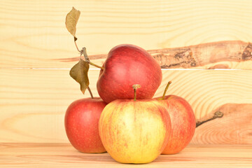 Ripe red apples, close-up, on a background of natural wood.