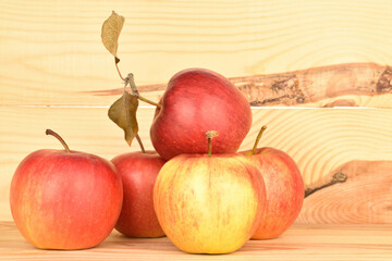 Ripe red apples, close-up, on a background of natural wood.