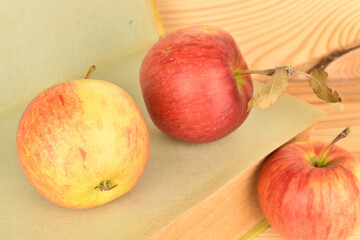Ripe red apples, close-up, on a background of natural wood.