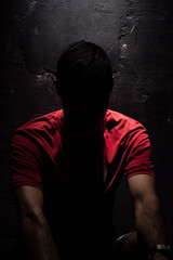 Studio shot of faceless man in red T-shirt