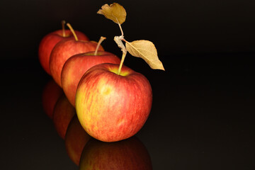 Ripe red apples, close-up, on a black background.