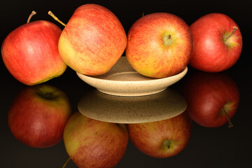 Ripe red apples, close-up, on a black background.