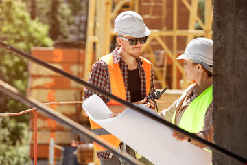 Fototapeta premium Two young architects or engineers discussing a project plan