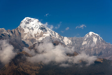 Annapurna South mountain peak with blue sky background in Nepal