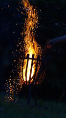 Fire basket with many sparks at night