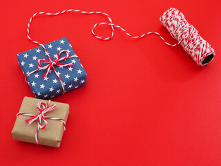 gift box package paper wrapping with star pattern and string on red background.