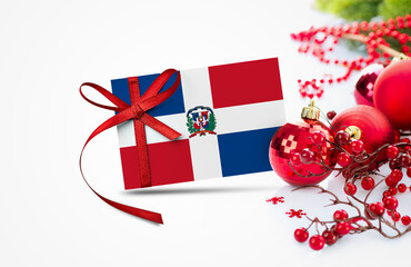 Dominican Republic flag on new year invitation card with red christmas ornaments concept. National...