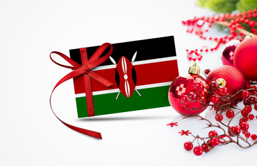 Kenya flag on new year invitation card with red christmas ornaments concept. National happy new year composition.