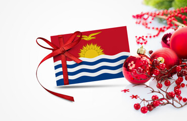 Kiribati flag on new year invitation card with red christmas ornaments concept. National happy new year composition.