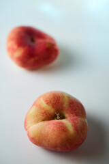 red ripe peaches on a white background. Close-up.