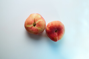 red ripe peaches on a white background. Close-up. Top view.