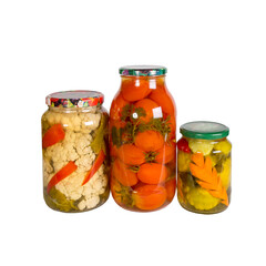 Canned vegetables in glass jars isolated on white background