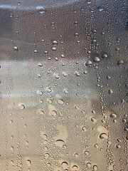 Water drops on a plastic bottle surface. Selective focus this image