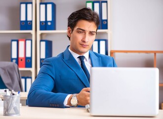 Young handsome businessman working in the office