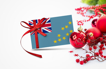 Tuvalu flag on new year invitation card with red christmas ornaments concept. National happy new...