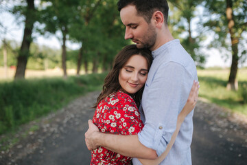 Portrait of beautiful couple walking in park. Happy young female with handsome man