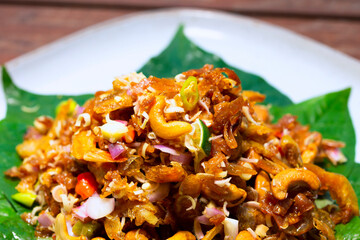 Herb spicy salad with fired shrimp and fish on plate