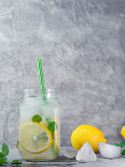 Glass jar of summer refreshing Mojito lemonade with lemon, mint and ice