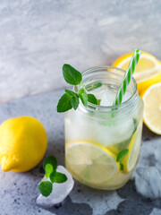 Glass jar of summer refreshing Mojito lemonade with lemon, mint and ice