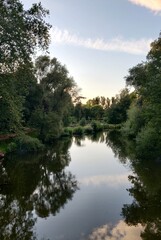 Fototapeta na wymiar Beautiful park river with amazing light reflections