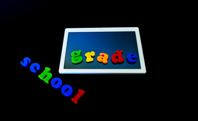 Tablet with text SCHOOL.Tablet PC, technology and education. Back to school concept