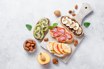 Sweet sandwiches with fruits and berries on white background.