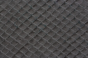 Metal mesh texture. Pattern of metal grid on a dark gray background. Perfect for design.