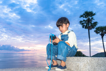 .A boy have fun at Promtep cape..Promthep cape is the most popular viewpoint in Phuket island. the most tourist always come to see sunset at this landmark