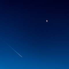 A plane flies under the Earth's Moon